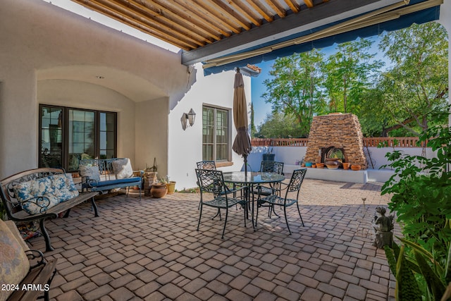 view of patio / terrace with an outdoor living space with a fireplace