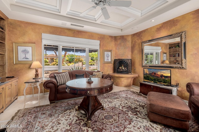 tiled living room featuring built in shelves, ceiling fan, crown molding, coffered ceiling, and beam ceiling