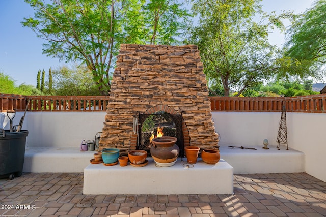 view of patio / terrace featuring an outdoor stone fireplace