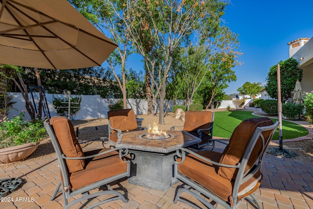 view of patio with a fire pit