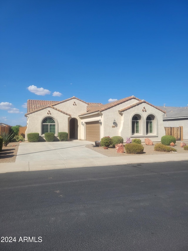 mediterranean / spanish house featuring a garage