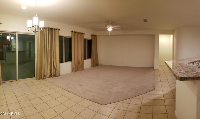 kitchen featuring light colored carpet, a kitchen island with sink, stainless steel appliances, and tasteful backsplash