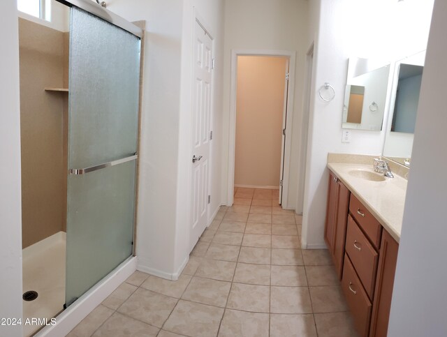 bathroom featuring vanity, tile patterned floors, and an enclosed shower