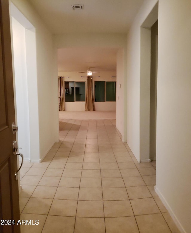 hall featuring light tile patterned floors