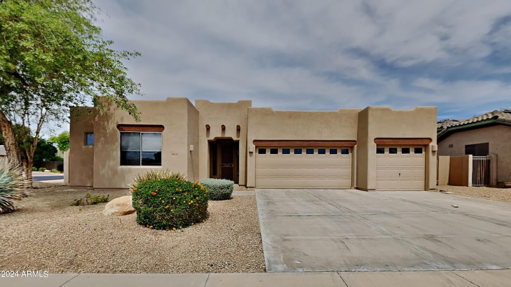 southwest-style home featuring a garage