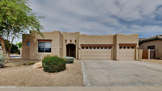 pueblo-style house with a garage