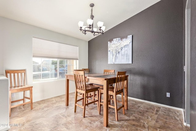 dining area with a notable chandelier and lofted ceiling