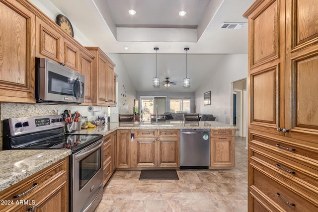 kitchen featuring kitchen peninsula, stainless steel appliances, a raised ceiling, ceiling fan, and lofted ceiling