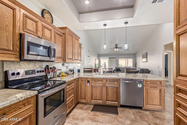 kitchen featuring sink, ceiling fan, decorative light fixtures, kitchen peninsula, and stainless steel appliances