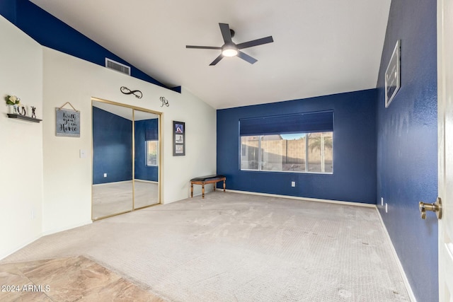 unfurnished room with carpet flooring, ceiling fan, and vaulted ceiling