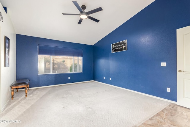 carpeted spare room with ceiling fan and lofted ceiling