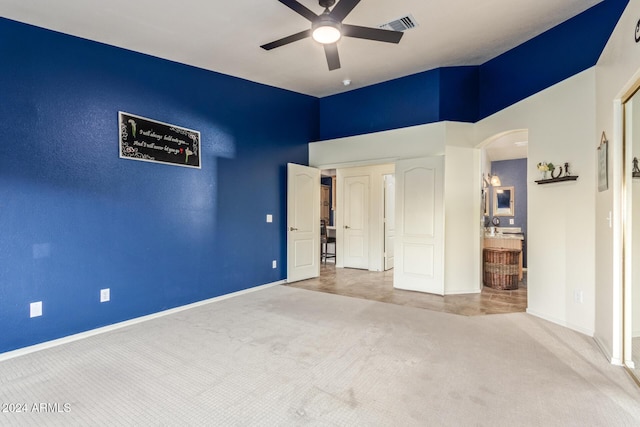 unfurnished bedroom featuring carpet flooring, ceiling fan, and connected bathroom