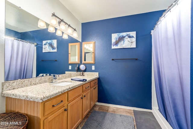 bathroom with tile patterned floors, vanity, and walk in shower