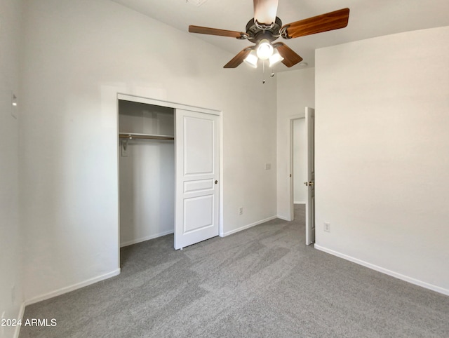 unfurnished bedroom featuring ceiling fan, light carpet, and a closet