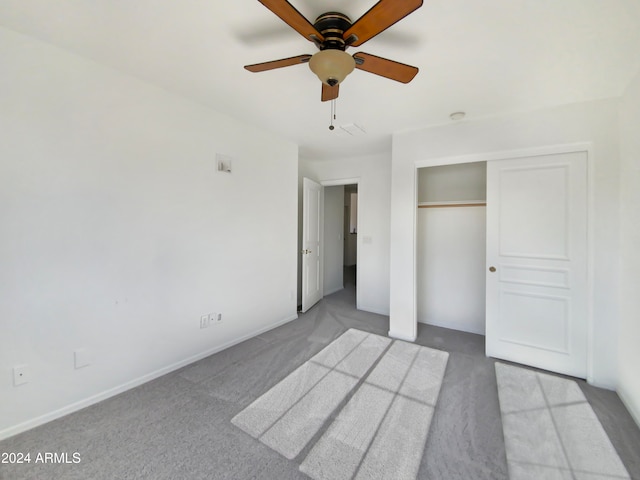 unfurnished bedroom featuring light carpet, a closet, and ceiling fan