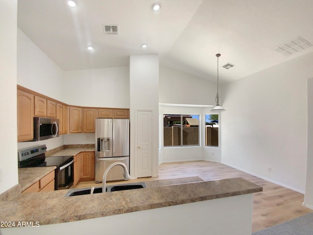 kitchen with sink, light wood-type flooring, decorative light fixtures, kitchen peninsula, and stainless steel appliances