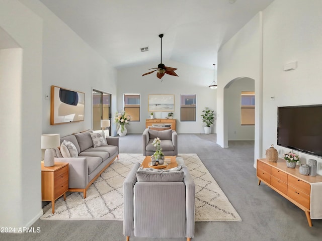 carpeted living room featuring ceiling fan and high vaulted ceiling