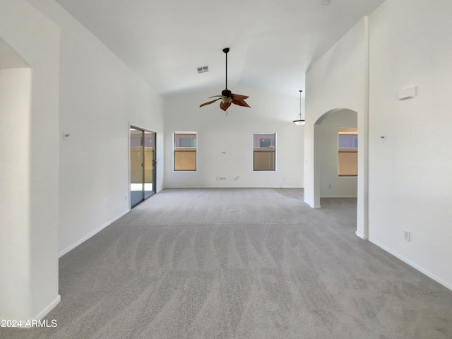 unfurnished living room with light colored carpet, high vaulted ceiling, and ceiling fan