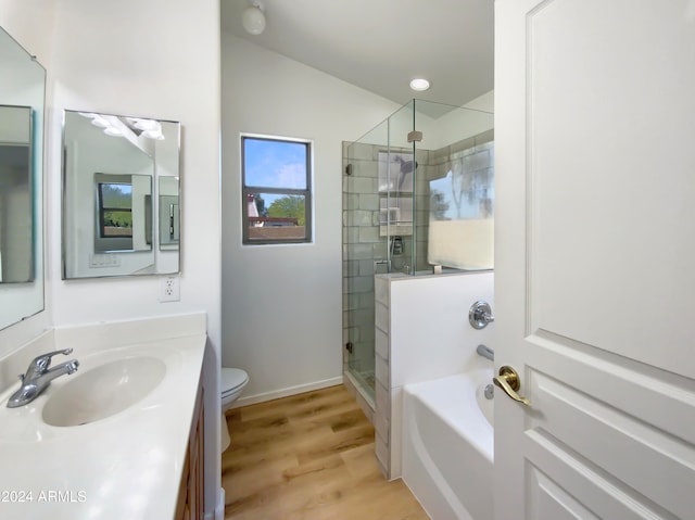 full bathroom with hardwood / wood-style floors, vanity, independent shower and bath, and toilet