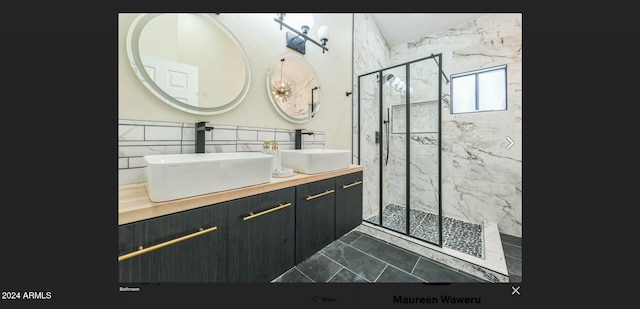 bathroom with vanity, tile patterned floors, tile walls, and a shower with shower door