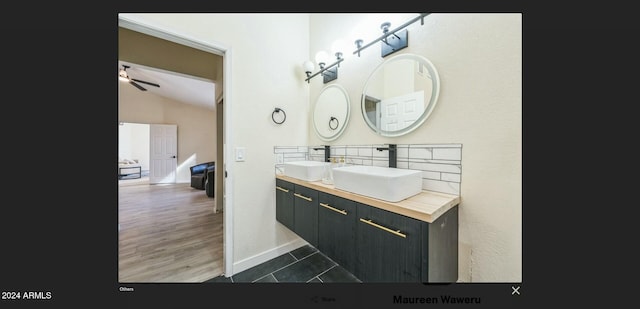 bathroom featuring wood-type flooring, vanity, vaulted ceiling, and ceiling fan