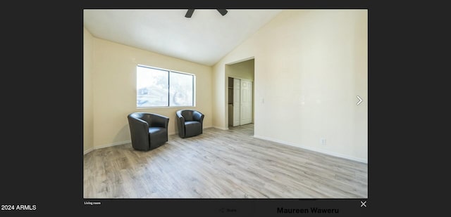 unfurnished room featuring ceiling fan, light wood-type flooring, and vaulted ceiling