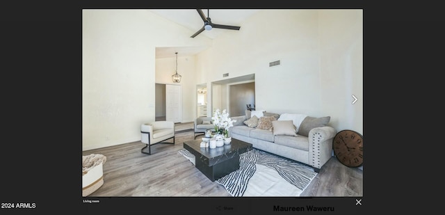 living room with ceiling fan, high vaulted ceiling, and hardwood / wood-style flooring