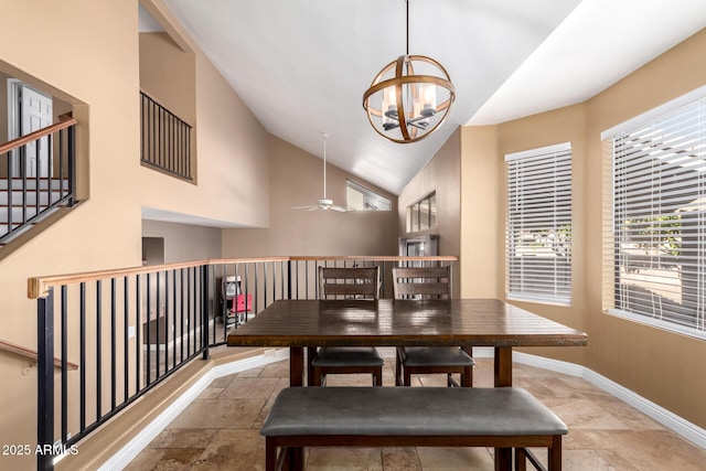 dining space featuring lofted ceiling and ceiling fan with notable chandelier