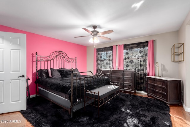 bedroom with ceiling fan and wood-type flooring