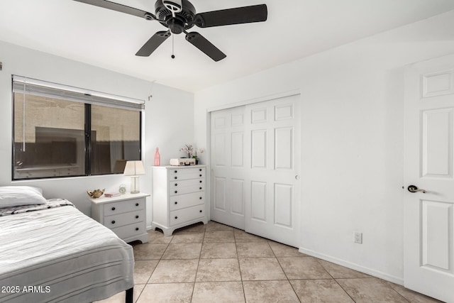 bedroom featuring ceiling fan, a closet, and light tile patterned floors