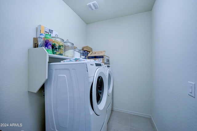 washroom with light tile patterned floors and separate washer and dryer