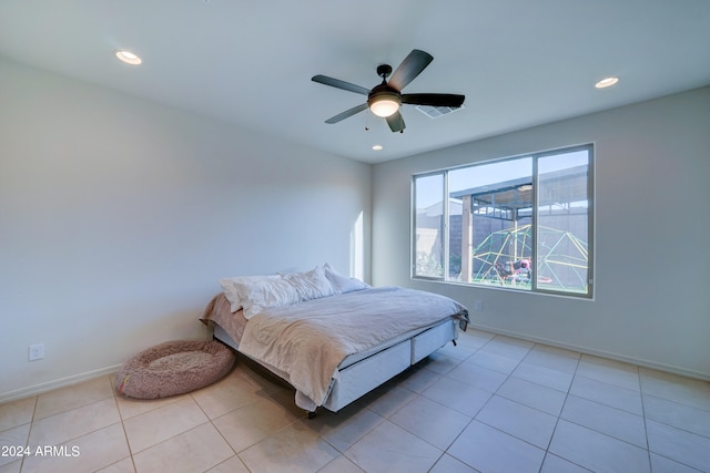 bedroom with ceiling fan and light tile patterned flooring