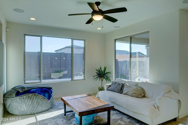 living room featuring a wealth of natural light and ceiling fan