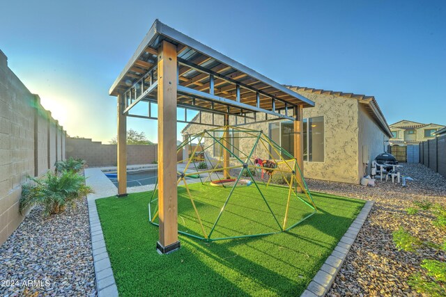 view of yard featuring a playground and a patio