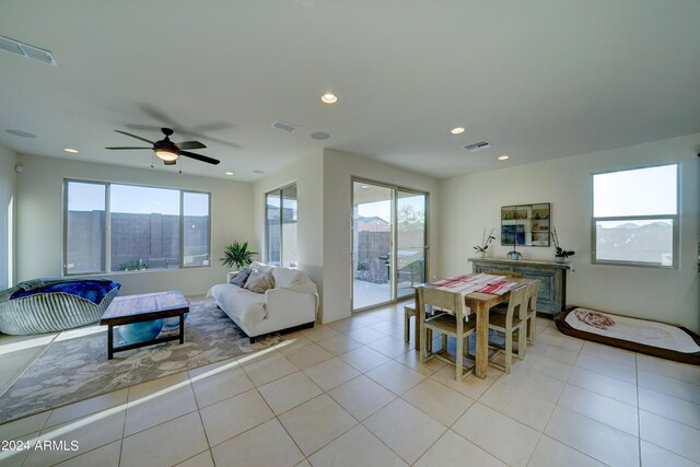 tiled living room featuring ceiling fan and plenty of natural light