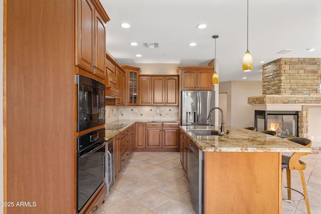 41627 N Cedar Chase Rd, Anthem, AZ 85086 - kitchen with black appliances, a sink, open floor plan, decorative backsplash, and light stone counters