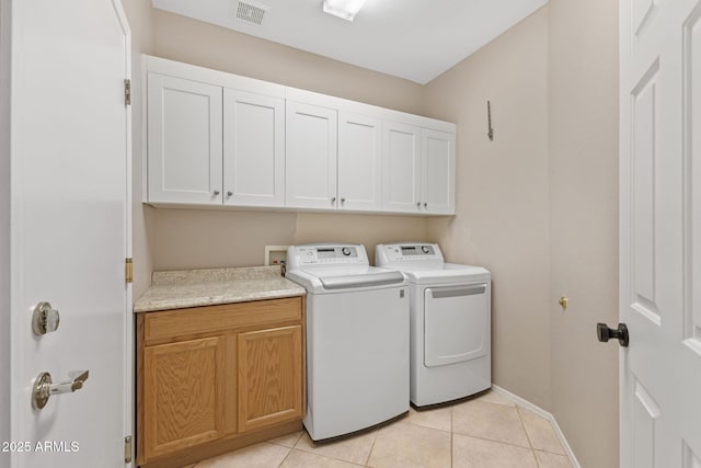 41627 N Cedar Chase Rd, Anthem, AZ 85086 - washroom featuring cabinet space, washer and dryer, baseboards, and light tile patterned flooring
