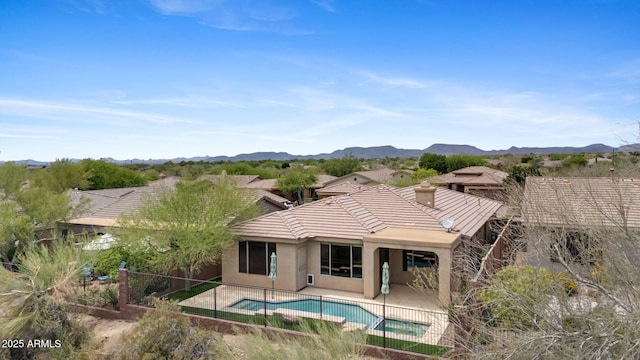 41627 N Cedar Chase Rd, Anthem, AZ 85086 - rear view of property with a fenced backyard, a tiled roof, stucco siding, a patio, and a chimney