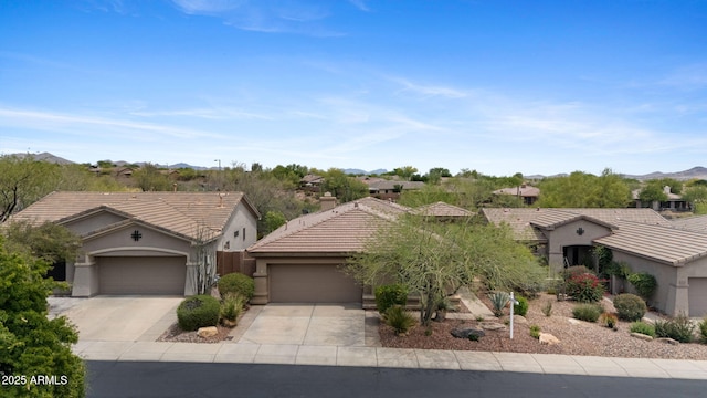 41627 N Cedar Chase Rd, Anthem, AZ 85086 - ranch-style home featuring a garage, driveway, stucco siding, a tile roof, and a mountain view