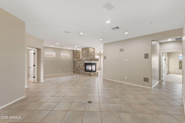 41627 N Cedar Chase Rd, Anthem, AZ 85086 - unfurnished living room with light tile patterned flooring, a stone fireplace, recessed lighting, and baseboards