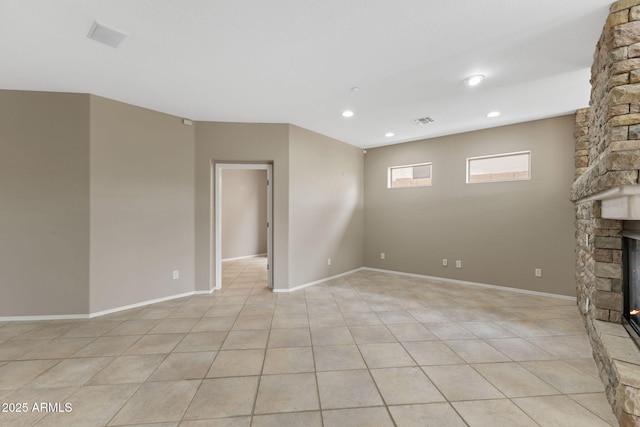 41627 N Cedar Chase Rd, Anthem, AZ 85086 - unfurnished living room featuring a stone fireplace, light tile patterned floors, recessed lighting, and baseboards