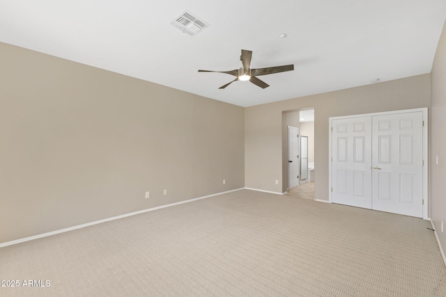 41627 N Cedar Chase Rd, Anthem, AZ 85086 - unfurnished bedroom with baseboards, light colored carpet, a ceiling fan, and ensuite bathroom