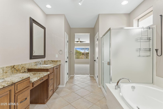 41627 N Cedar Chase Rd, Anthem, AZ 85086 - bathroom with a stall shower, vanity, a garden tub, tile patterned flooring, and baseboards