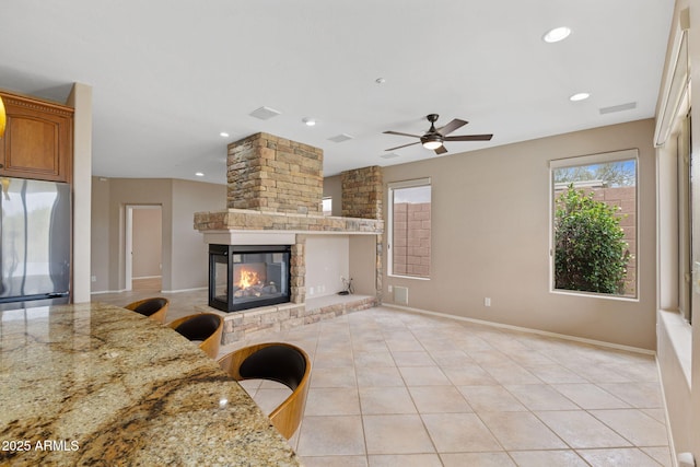 41627 N Cedar Chase Rd, Anthem, AZ 85086 - living area featuring ceiling fan, a multi sided fireplace, light tile patterned floors, recessed lighting, and baseboards