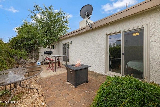 view of patio / terrace with a fire pit and outdoor dining space
