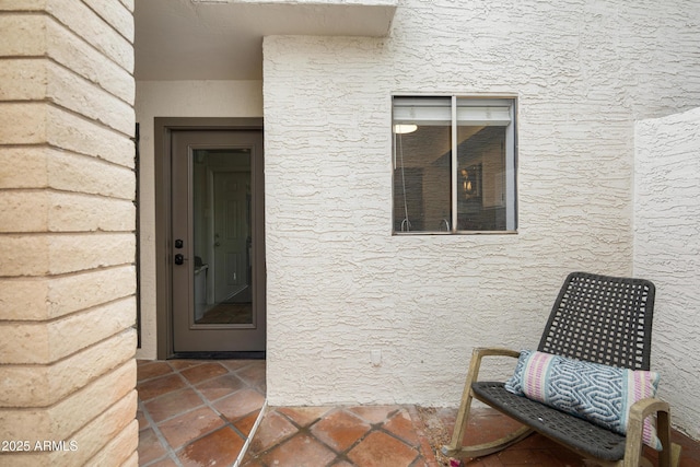 doorway to property with stucco siding