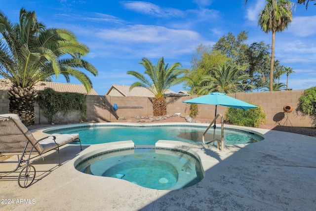 view of swimming pool featuring an in ground hot tub