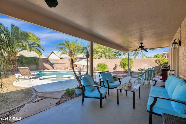 view of patio with a fenced in pool, outdoor lounge area, and ceiling fan