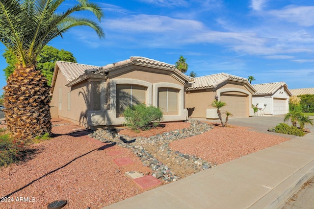 mediterranean / spanish-style home with a garage