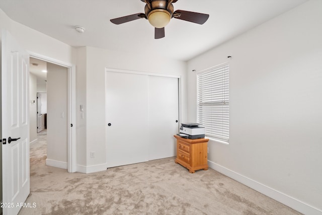 bedroom featuring carpet floors, ceiling fan, baseboards, and a closet